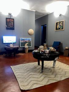 a living room with a coffee table on a rug at Shambani Homestay in Moshi