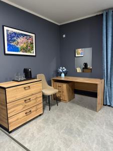 an office with a wooden desk and a dresser at Loft hotel in Karagandy