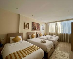 Ένα ή περισσότερα κρεβάτια σε δωμάτιο στο maj pharaoh pyramids view