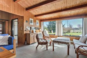 a living room with a couch and a table at M21012-Gedser-Allingsgavevej-2 in Gedser +8 photos