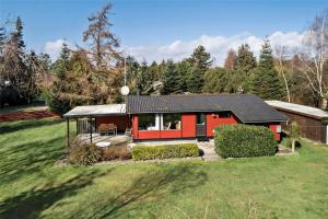 a red house with a black roof in a field at M21012-Gedser-Allingsgavevej-2 in Gedser