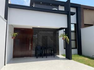 a modern house with a black and white facade at Casa Solar Beach in Vilhena
