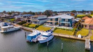 a boat docked at a marina next to houses at Locanda in Paynesville