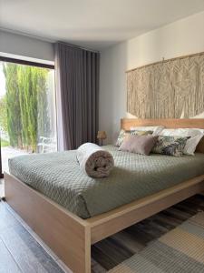 a bedroom with a large bed with a large window at Casa D' Almeidas in Amares +47 photos