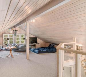 a room with a loft with a bed and a couch at L26-Rodby-Tjornevaenget-9 in Rødby