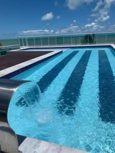 a swimming pool on top of a building at Blue Sunset com Varanda - Experience in João Pessoa