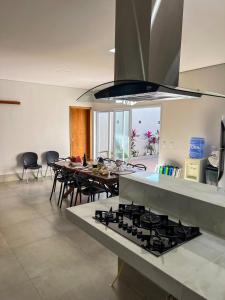 a kitchen with a stove and a table with chairs at Casa Zeluz in Chapada dos Guimarães +13 photos
