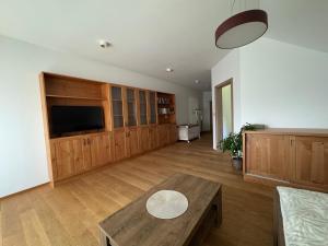 a large living room with a table and a tv at Restaurace Přístav Kostkov in Návsí u Jablunkova