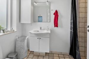 a bathroom with a sink and a mirror at M318-Vaeggerlose-Marielyst-Strandvej-63-S in Marielyst +13 photos