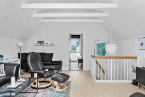 a living room with black leather chairs and a table at M318-Vaeggerlose-Marielyst-Strandvej-63-S in Marielyst