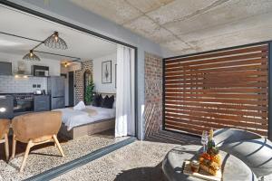 a bedroom with a bed and a table in a room at Lira On White Soil in Cape Town