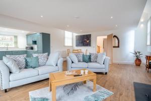 a living room with two couches and a table at 1 Bed in Tasburgh oc-t28242 in Ashwellthorpe