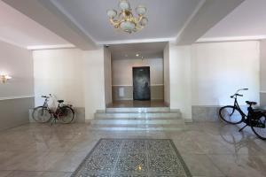 two bikes parked in a room with a chandelier at Northern Lights small apartment A at Emmas Street 28, Riga in Riga +9 photos