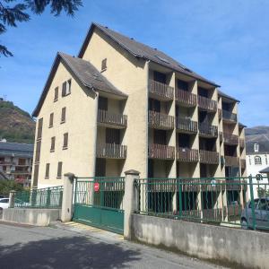 a large apartment building with a green fence at Studio SAFARI in Superbagnères