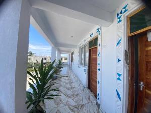 a hallway of a house with blue and white tiles at Watamu Plaza Apartments in Watamu