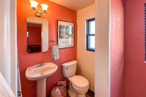 a bathroom with a toilet and a sink at Hummingbird Hideaway in Tucson +9 photos