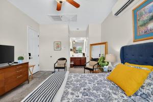 a bedroom with a blue bed and a tv at Elm Casita Apts in Litchfield Park