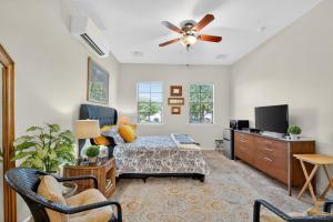 a living room with a bed and a ceiling fan at Elm Casita Apts in Litchfield Park
