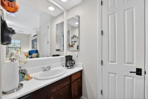 a bathroom with a sink and a mirror at Elm Casita Apts in Litchfield Park +26 photos