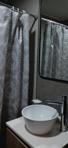 a bathroom with a white sink and a mirror at Studio Ezeiza Aeropuerto 204 in Ezeiza