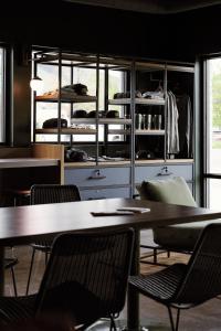 a room with tables and chairs and bunk beds at LOGE Missoula in Missoula