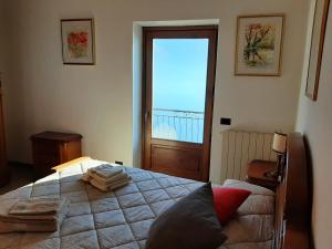 a bedroom with a bed and a large window at Betty's Balcony, Wonderful Lake View in San Siro +75 photos