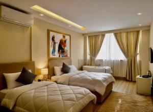 a hotel room with two beds and a window at Bedouin Camp pyramids view INN in Cairo +130 photos