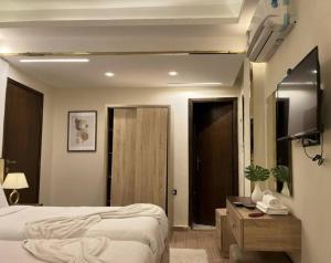 a bedroom with two beds and a table and a mirror at Bedouin Camp pyramids view INN in Cairo