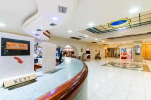 a lobby of a store with a reception counter at Topaz Hotel in St Paul's Bay