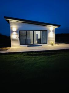 a small house with lights on it at night at Kildare Holiday Apartments No 3 in Kildare
