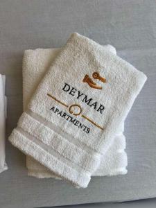 a white towel with the word denmark on it at Deymar Apartments VIEW in Vidin