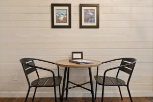 a table with two chairs and a book on it at Hidden Gem Cabin in Hungry Horse, Firepit, Close to Glacier in Hungry Horse