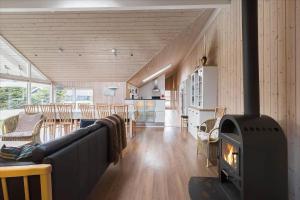 a living room with a fireplace in a house at M187-Vaeggerlose-Baeverstien-48 in Marielyst