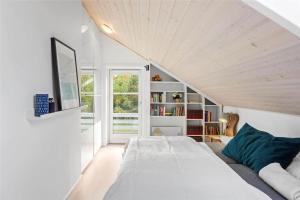 a bedroom with a large bed and a book shelf at L18-Rodby-Vibevej-9 in Rødby
