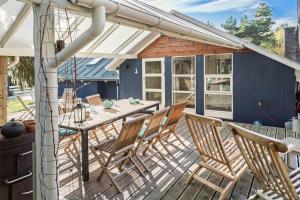 a patio with a table and chairs on a deck at L18-Rodby-Vibevej-9 in Rødby +13 photos