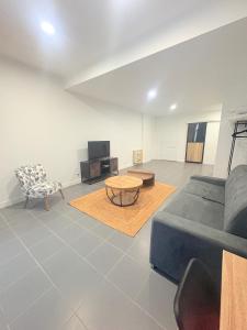 a living room with a couch and a table at Les chambres du Vignoble in Pauillac