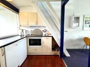 a kitchen with white cabinets and a staircase at M358-Vaeggerlose-Norrevang-38 in Bøtø By