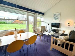 a living room with a couch and a table and chairs at M358-Vaeggerlose-Norrevang-38 in Bøtø By