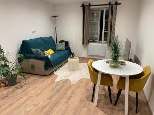 a living room with a couch and a table at chambresdusoleil in Hoffen +79 photos