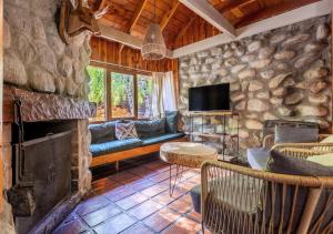 a living room with a couch and a fireplace at Ruma Andina by DOT Cabana in Villa La Angostura +63 photos