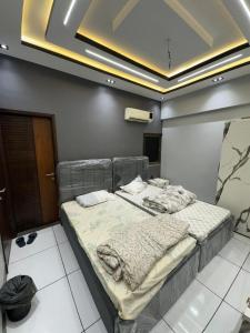 a bedroom with two beds in a room at Double Delight-Two Single Beds, Private Entrance Available On Sharing Also in Karachi