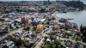 an aerial view of a city next to a body of water at Hotel Museo El Greco Puerto Varas in Puerto Varas