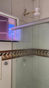 a glass counter in a bathroom with a light at Hotel Itiquira in Formosa