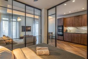 a bedroom with glass walls and a bed in a room at Golden Dunes & SPA in Nida