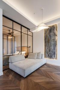 a bedroom with a large bed and wooden floors at Golden Dunes & SPA in Nida