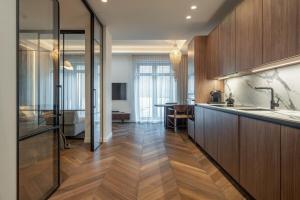 a kitchen with wooden cabinets and a counter top at Golden Dunes & SPA in Nida