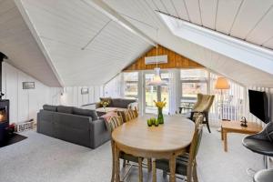a living room with a table and a couch at M365-Gedser-Lollandsvej-9 in Gedser
