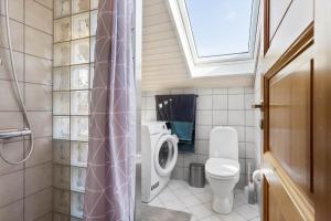 a small bathroom with a toilet and a window at M365-Gedser-Lollandsvej-9 in Gedser +9 photos