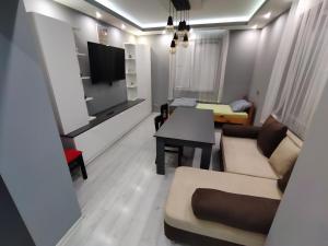 a living room with a couch and a table at При митака in Pernik