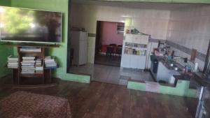 a living room with a large flat screen tv at Pousada do Seu Claudionor in Belém